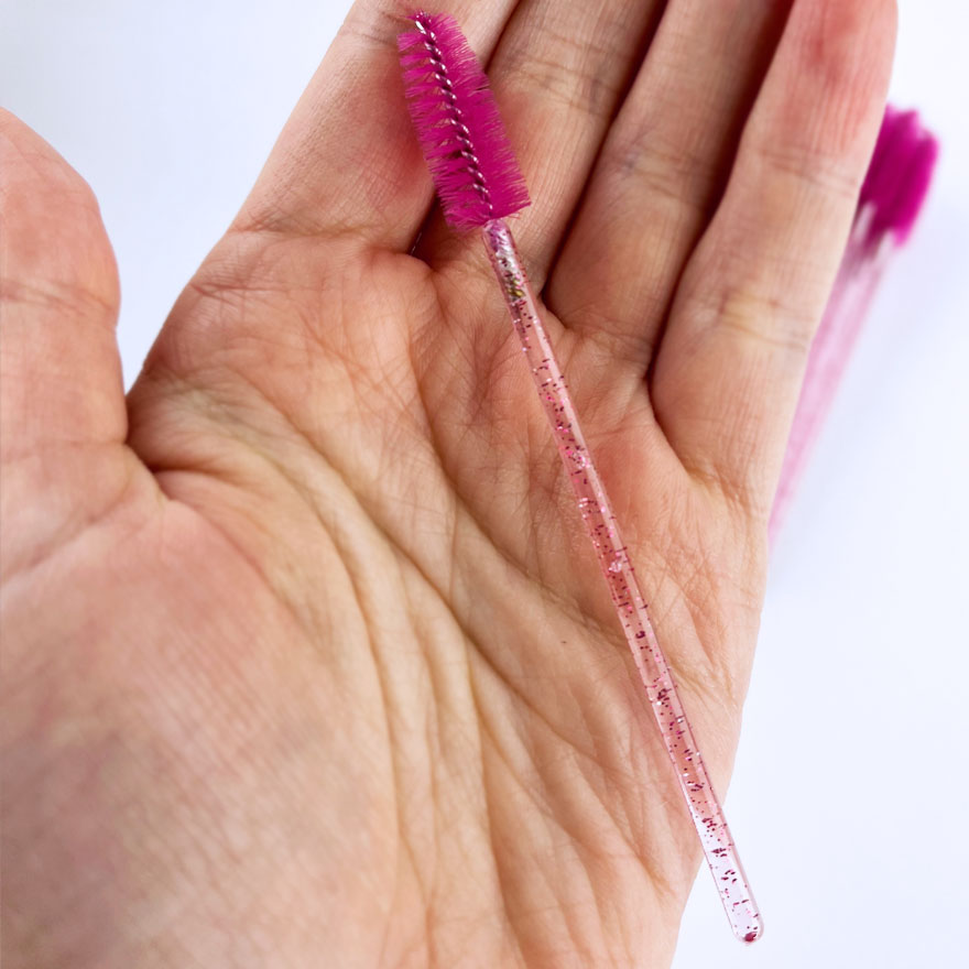 Eyelash brush, nylon, fuchsia on a transparent base with pink glitter (50 pcs/pack)