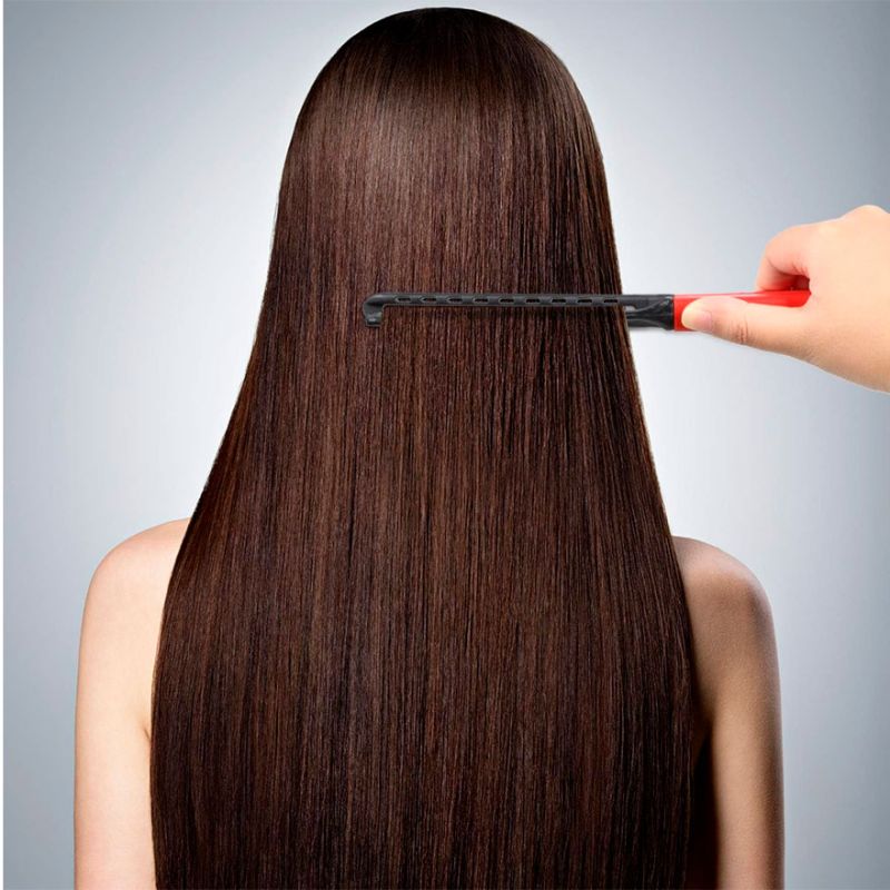 Comb-iron for drying hair with a hairdryer and for leveling with an iron, pink with black