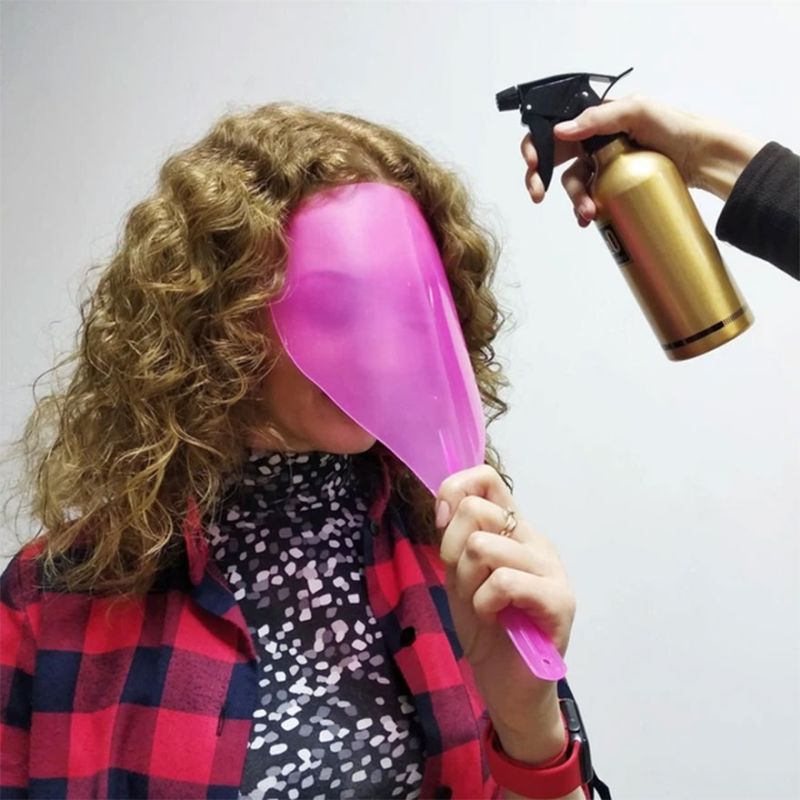 Protective face shield with transparent handle